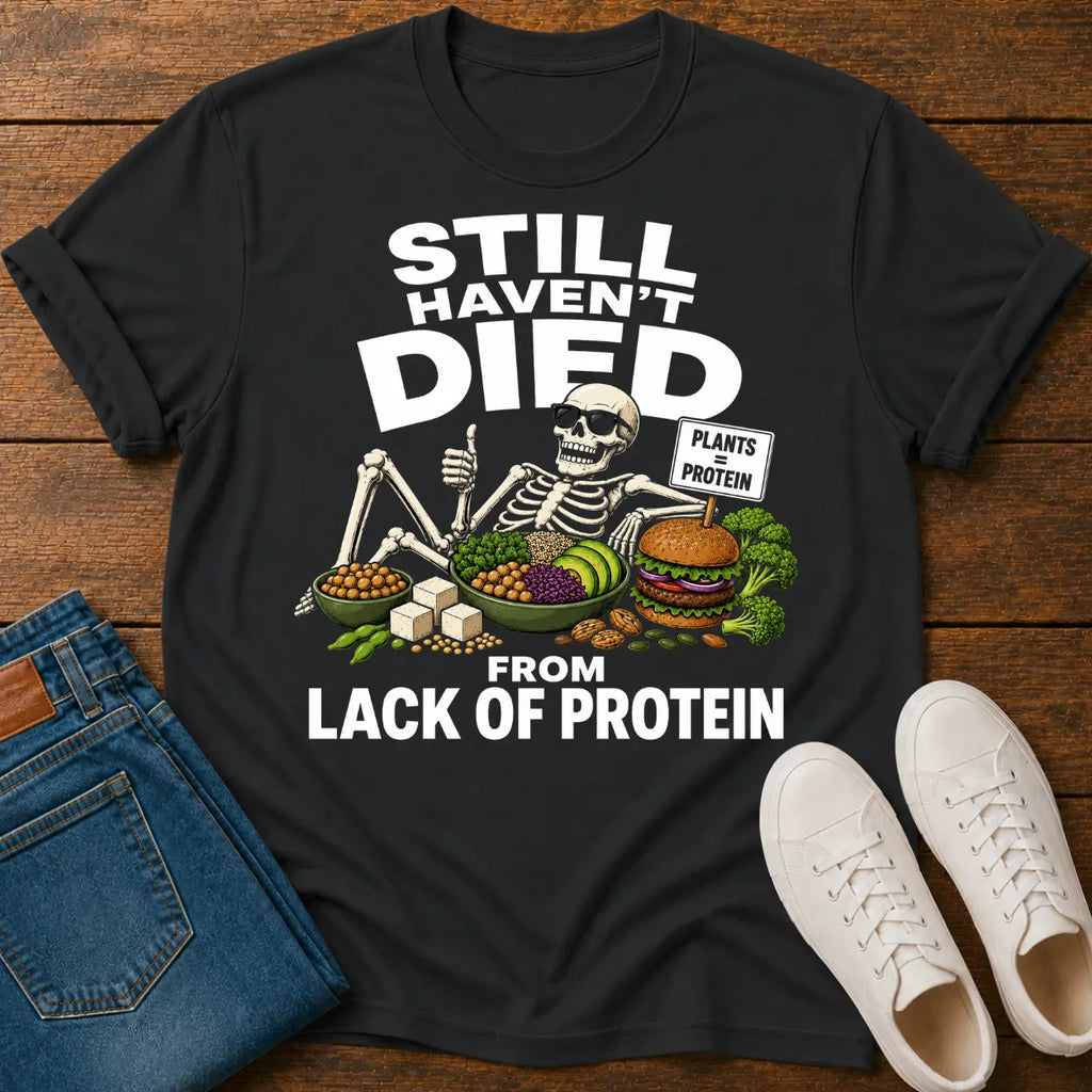 black t=shirt with a skeleton graphic and text 'still haven't dies from lack of protein'