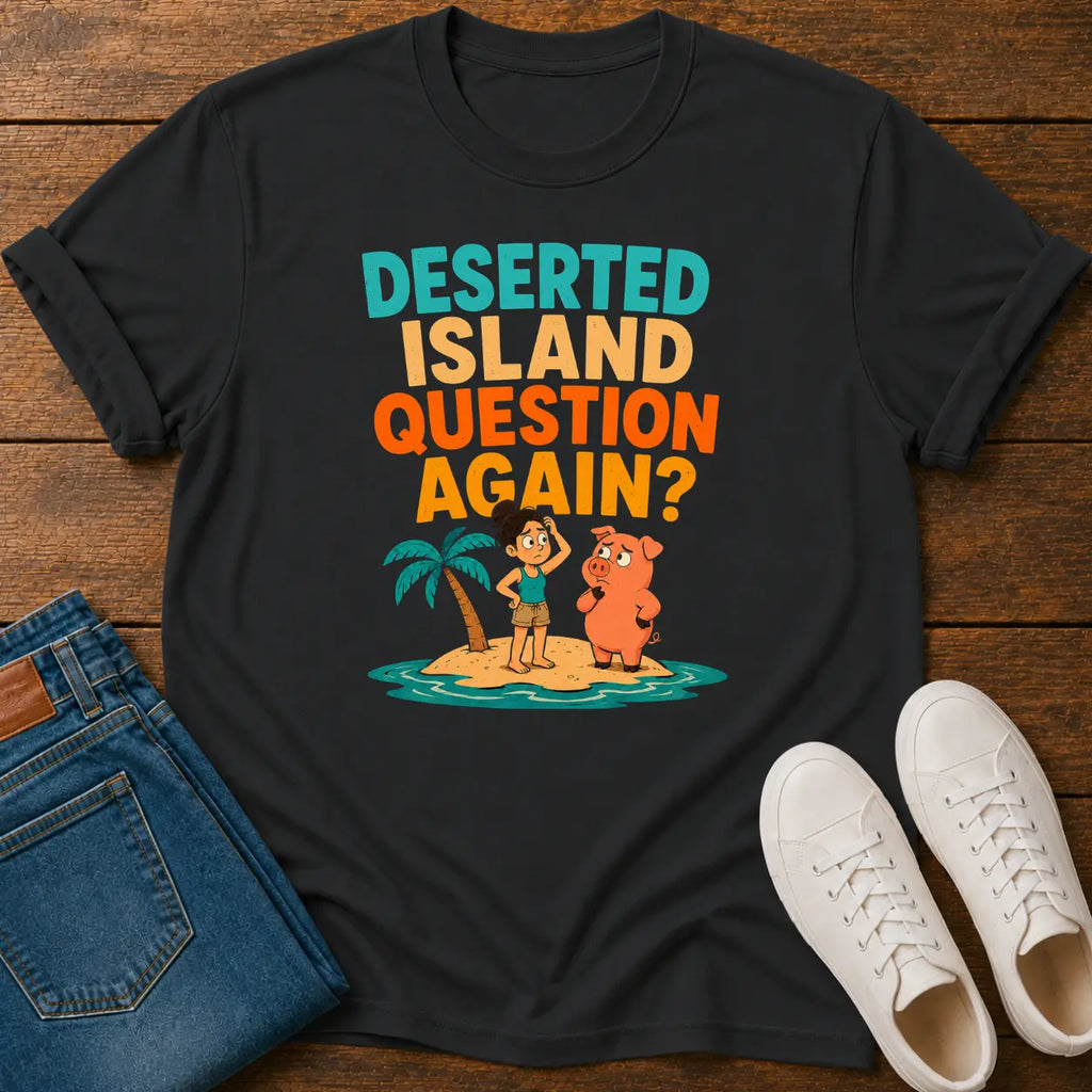 A black graphic t-shirt laid flat on a wooden surface, styled with blue jeans and white sneakers. The t-shirt features a colorful retro graphic with the text 'DESERTED ISLAND QUESTION AGAIN?' and cartoon characters on a small island.