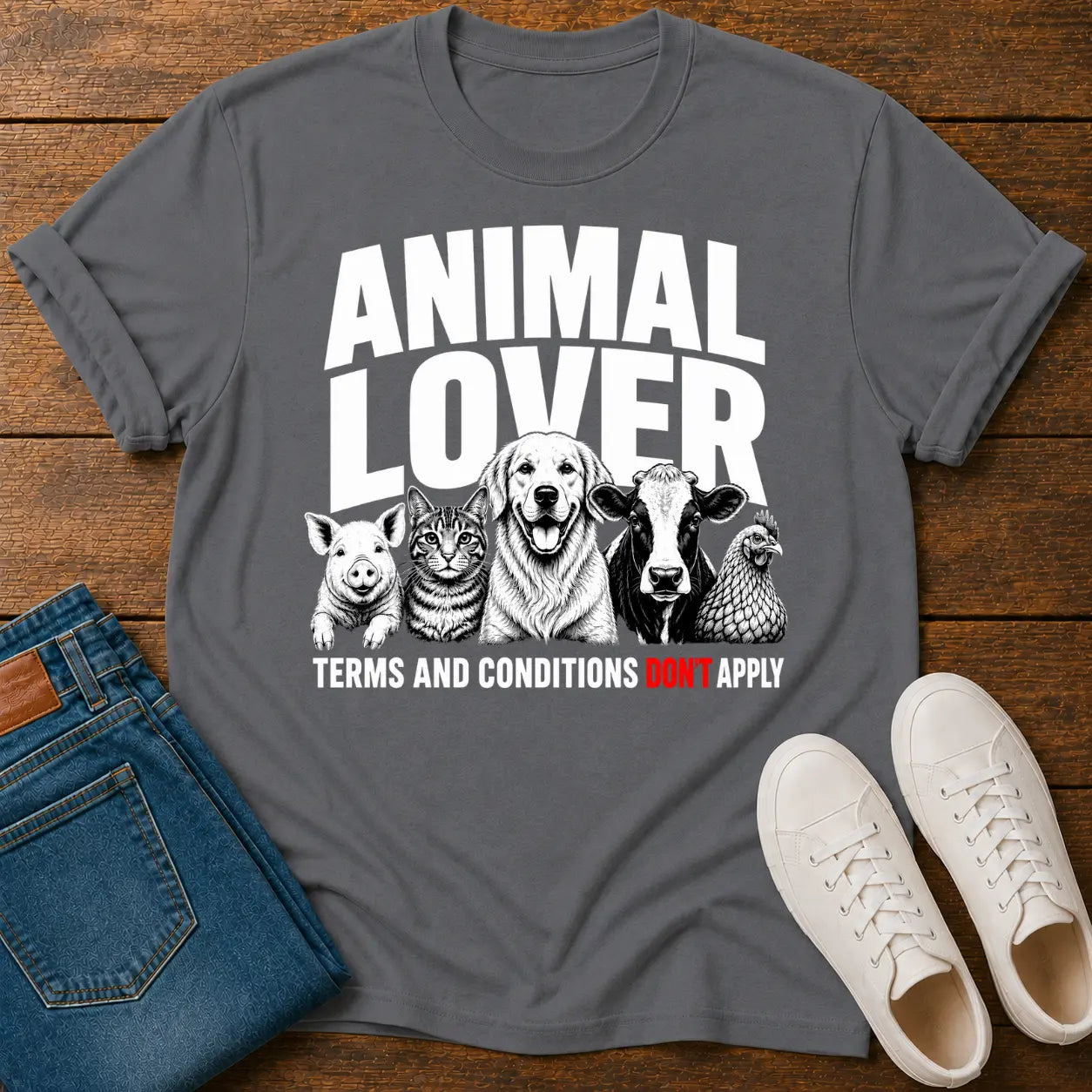 Gray t-shirt with 'Animal Lover' graphic on a wooden surface with jeans and shoes.