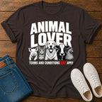 Black t-shirt with 'Animal Lover' graphic on a wooden surface with jeans and shoes.