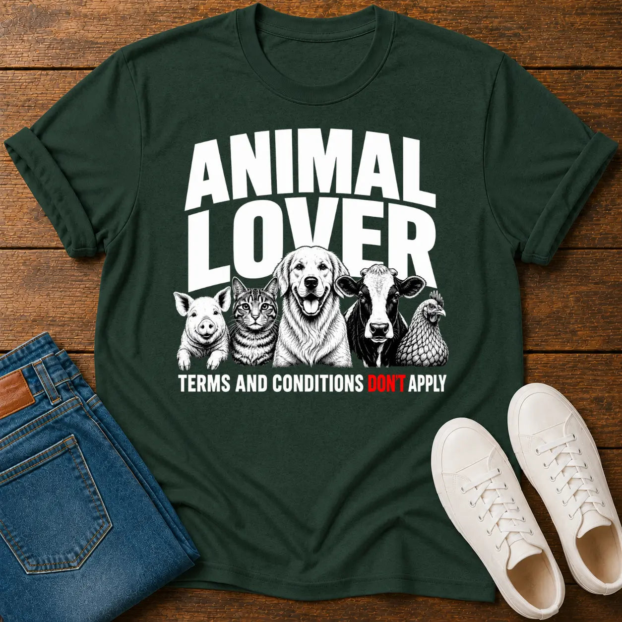 Green t-shirt with animal lover graphic on a wooden surface with jeans and shoes.