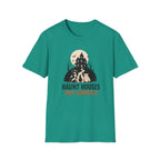 A teal green short-sleeve crewneck t-shirt with a Halloween graphic on the chest. The graphic features a haunted house, bats, a full moon, and three dogs, with the text 'HAUNT HOUSES NOT ANIMALS' in dark green and orange.