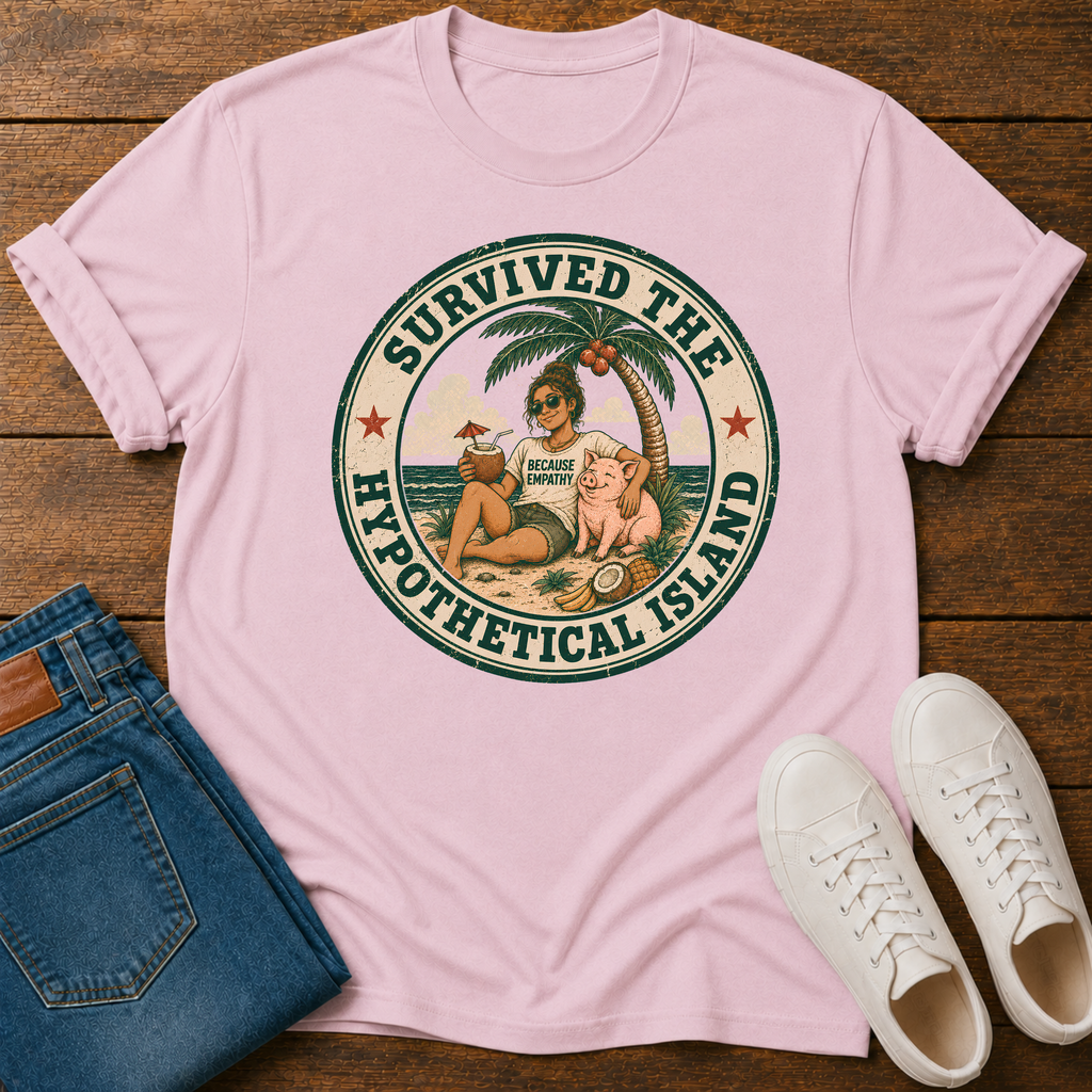 A light pink short-sleeve graphic T-shirt laid flat on a wooden surface, styled with folded blue jeans and white sneakers. The shirt features a circular retro beach illustration with the text 'SURVIVED THE HYPOTHETICAL ISLAND' and a small 'Tropical Island' logo in the center.