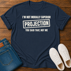 Navy t-shirt with vegan slogan i'm not morally superior you said that not me on a wooden board styled with jeans and sneakers.