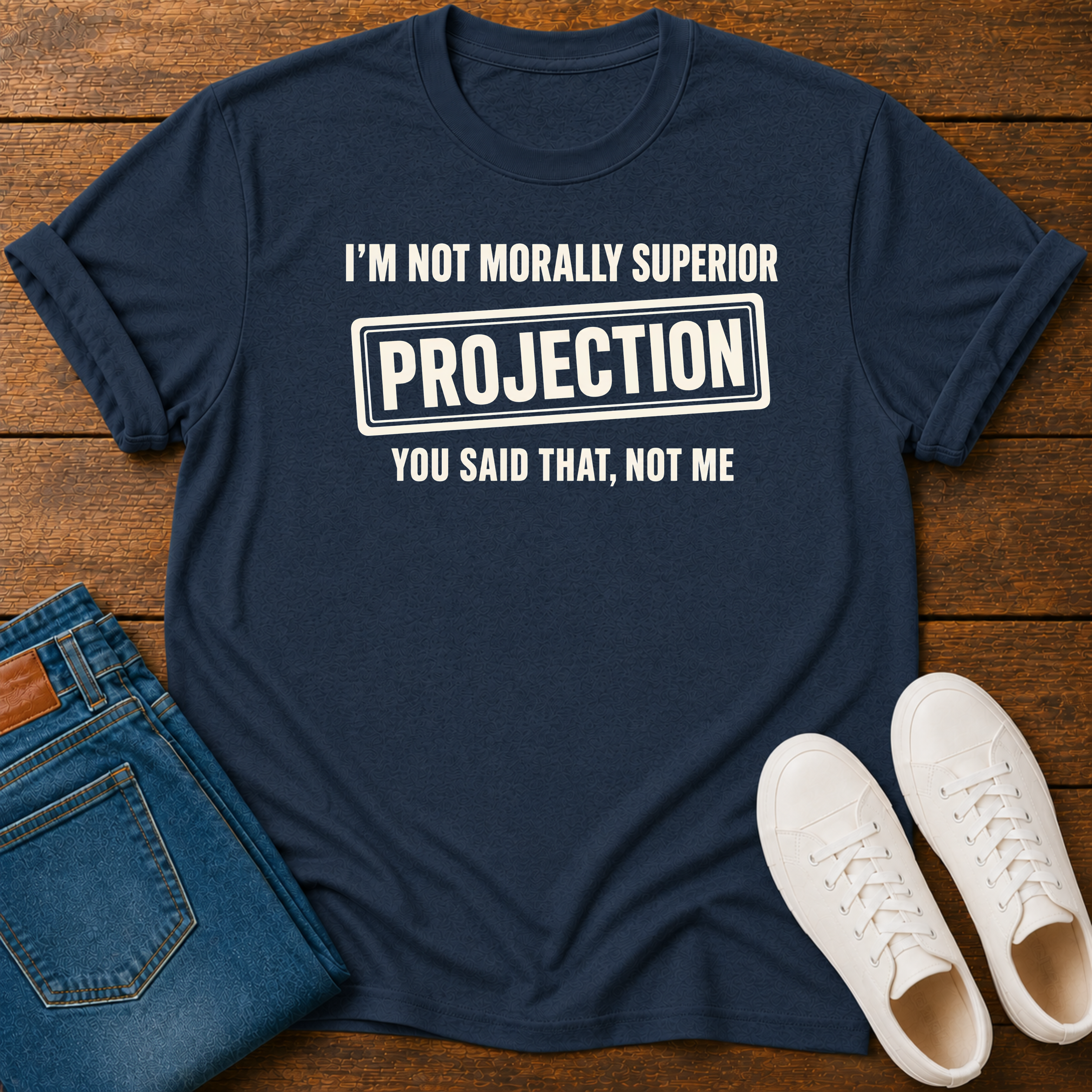 Navy t-shirt with vegan slogan i'm not morally superior you said that not me on a wooden board styled with jeans and sneakers.