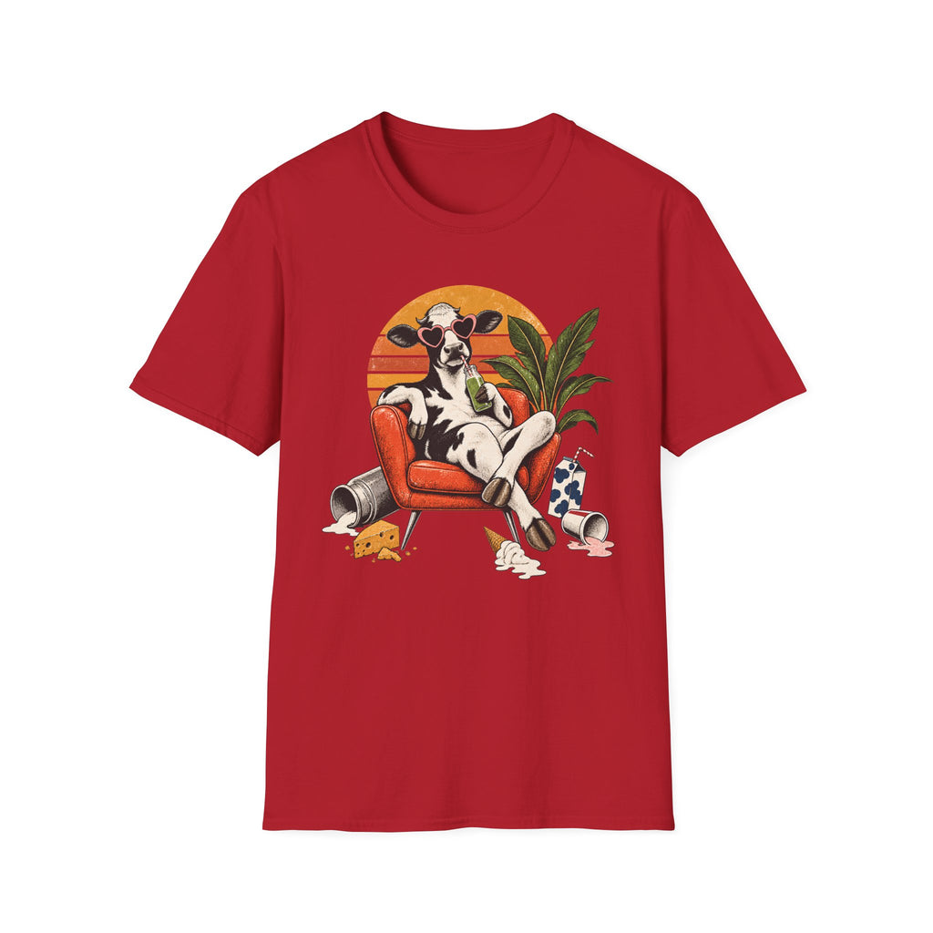 A red short-sleeve crewneck t-shirt featuring a colorful graphic print of a cow lounging in an orange armchair against a sunset background.