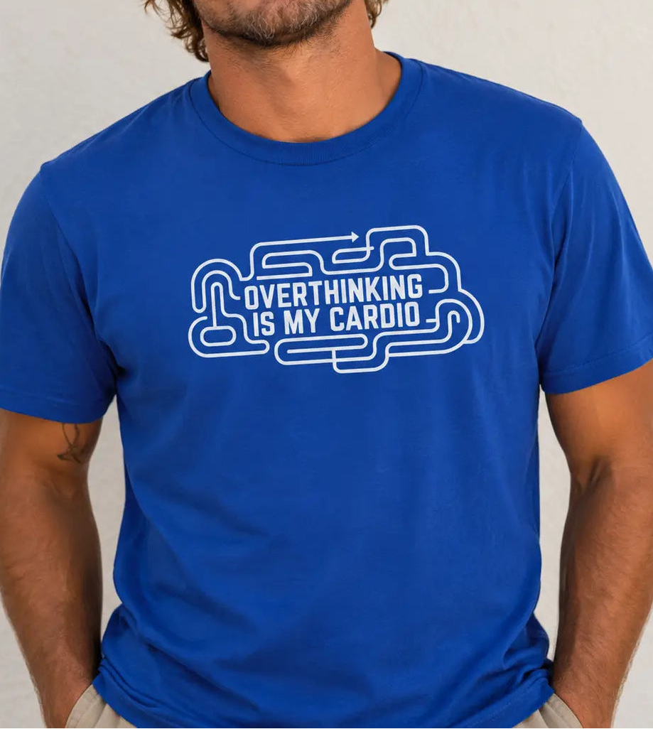 A man wearing a royal blue crewneck t-shirt with a white graphic outline of a brain and the text 'OVERTHINKING IS MY CARDIO'.