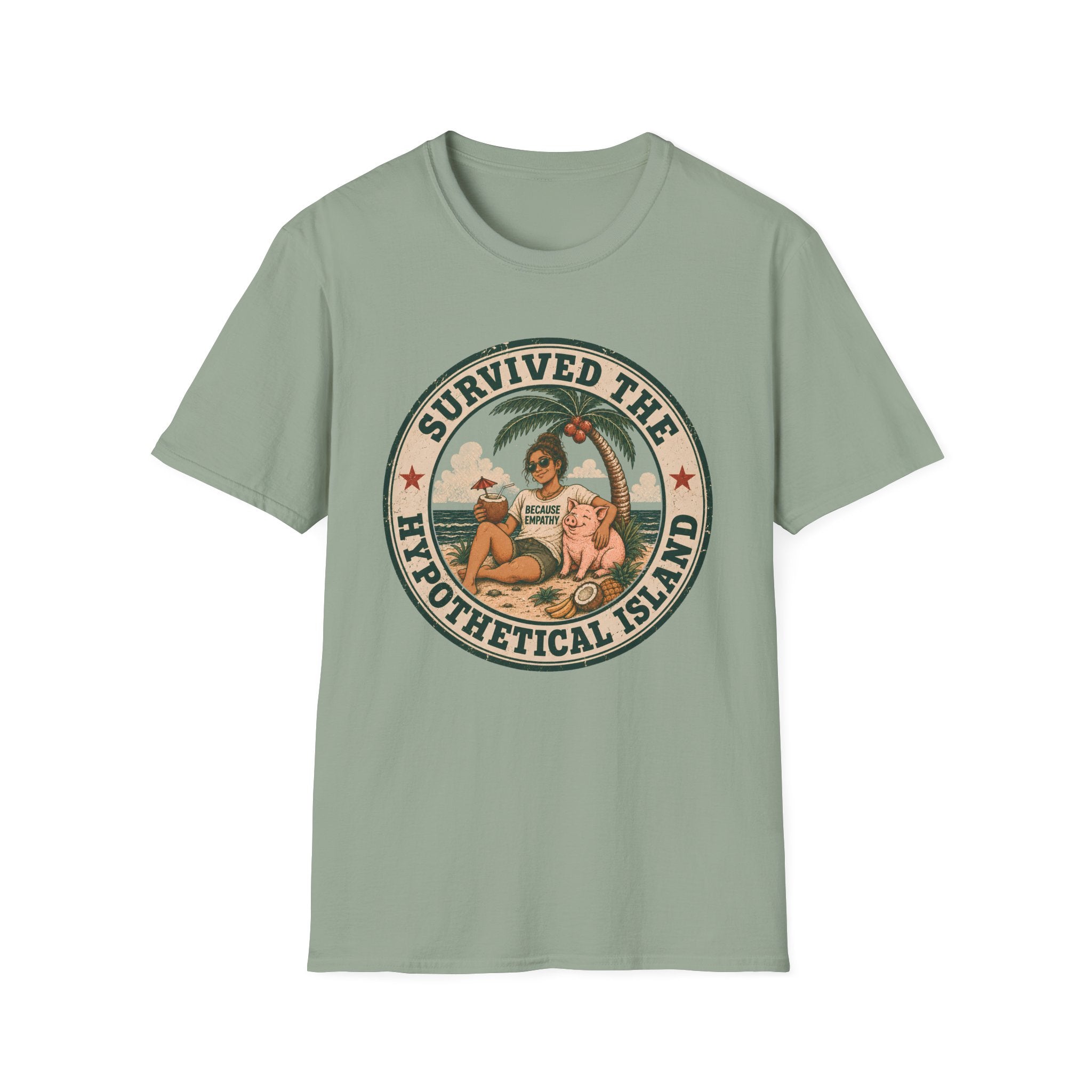 A sage green graphic t-shirt laid flat on a wooden surface, styled with folded blue jeans and a pair of white sneakers. The t-shirt features a circular retro graphic with the text 'SURVIVED THE HYPOTHETICAL ISLAND' and an illustration of a woman and a pig on a beach.