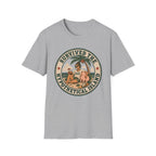 A light gray heather crewneck t-shirt featuring a circular retro graphic on the chest with a woman and a pig on a beach under a palm tree, with the text 'SURVIVED THE HYPOTHETICAL ISLAND'.
