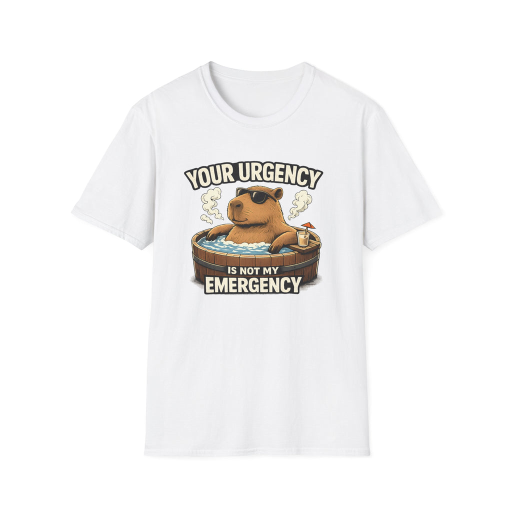 A white short-sleeve crewneck t-shirt featuring a cartoon graphic of a capybara relaxing in a hot tub with the text 'YOUR URGENCY IS NOT MY EMERGENCY'.